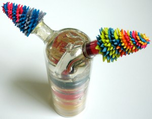 Leo Jean's Starlike© Opposites; paper sculptures atop bottle with layered color resin interior