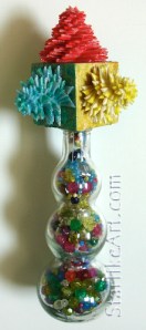 Leo Jean's Starlike© paper sculptures mounted on wooden cube atop glass