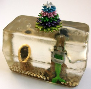 Leo Jean's Starlike© paper sculpture atop mermaid figurine imbedded in resin