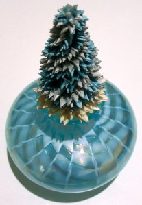 Leo Jean's Starlike© paper sculpture mounted on shiny blue glass