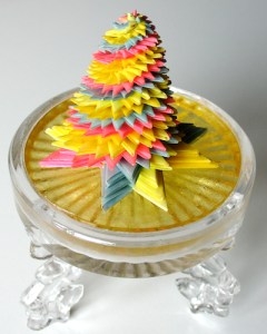 Leo Jean's Starlike© paper sculpture atop tri-legged glass pedestal